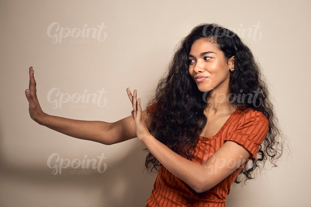Mixed race woman gesturing stop sign