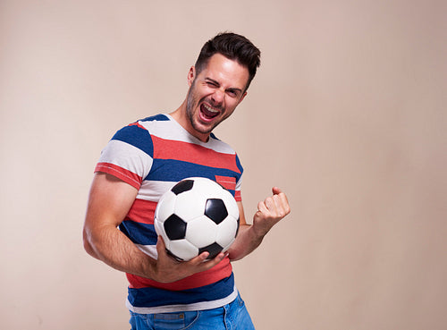 Excited football fan supporting his team