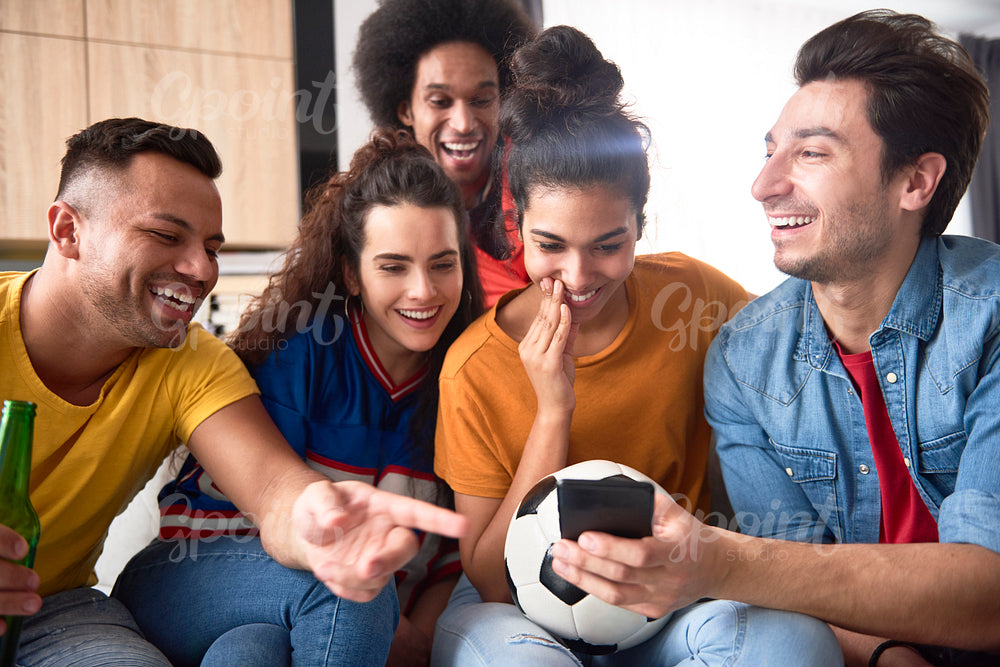 Group of friends watching something funny on the phone
