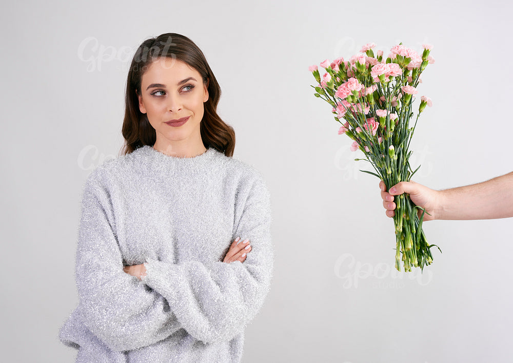 Man's hand giving beautiful woman flowers