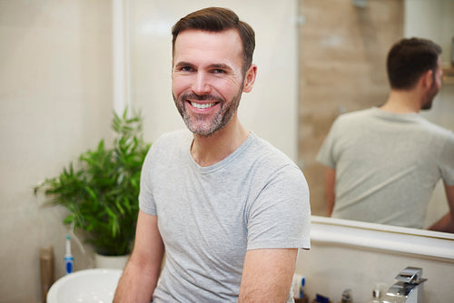 Portrait of smiling man in the bathroom