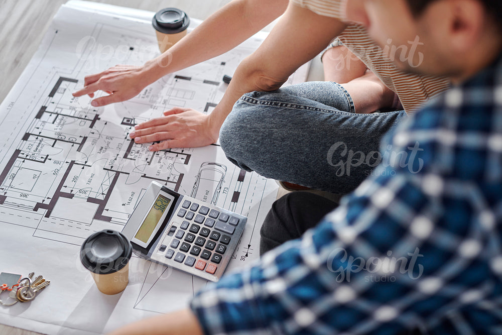 Close up of couple calculating costs of new house