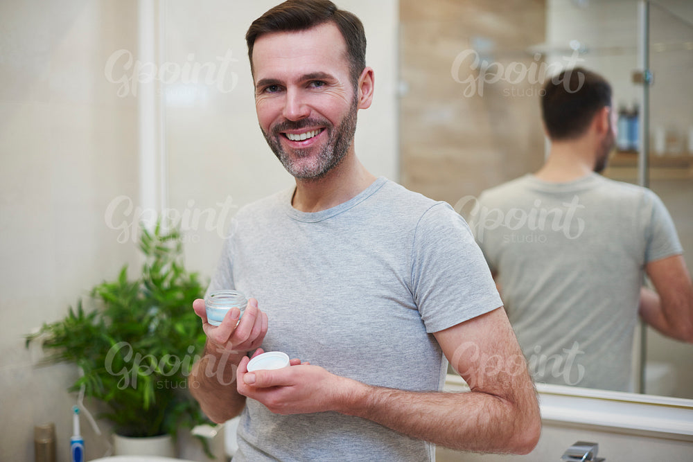 Portrait of mature men holding beauty product
