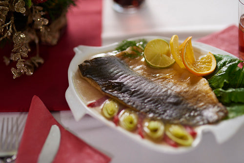 Delicious carp decorated with vegetables and citrus