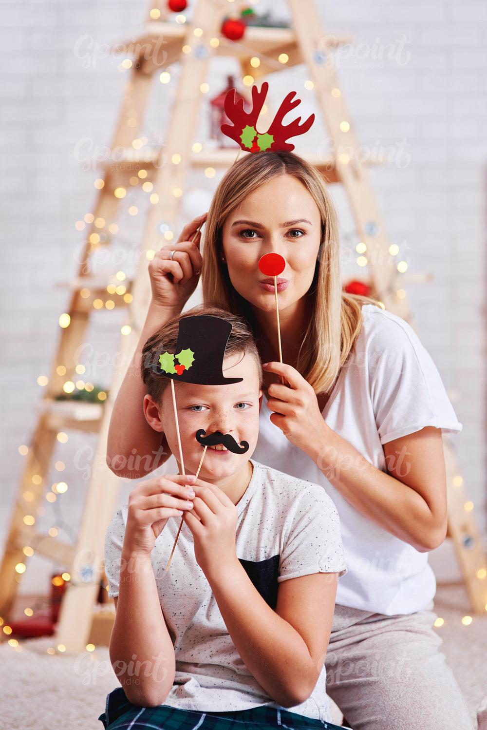 Portrait of mother and son with funny mask