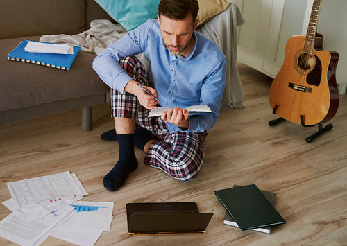 Man at home office working on the floor