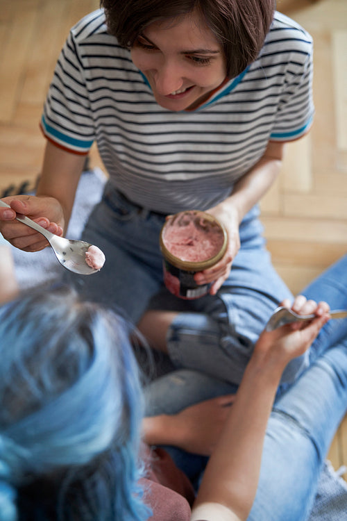 Top view of women sitting and eating ice cream
