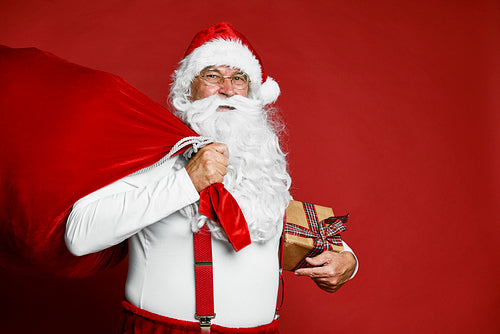 Portrait of caucasian Santa Claus with sack of presents