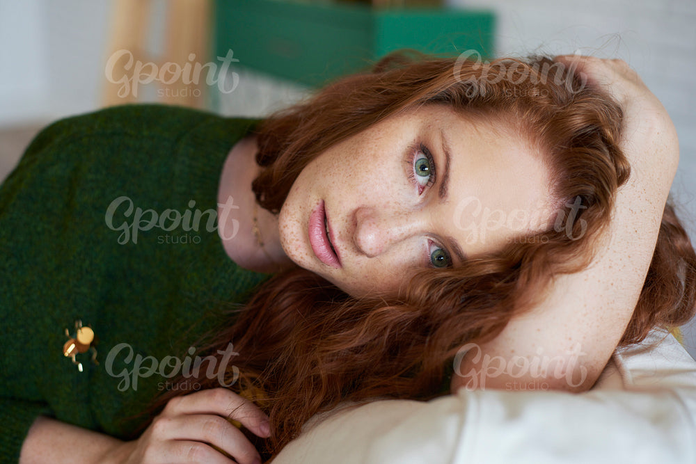 Shot of worried girl lying on sofa
