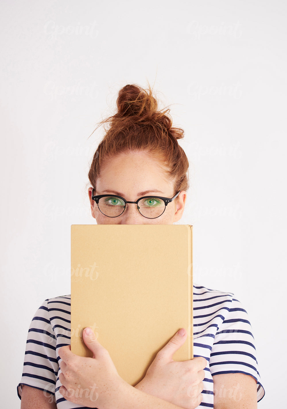 Portrait of student holding a book at studio shot