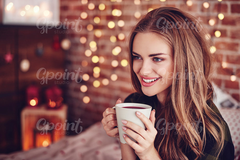 Attractive woman drinking hot tea