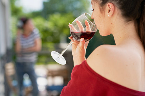 Rear view of woman drinking wine outdoors