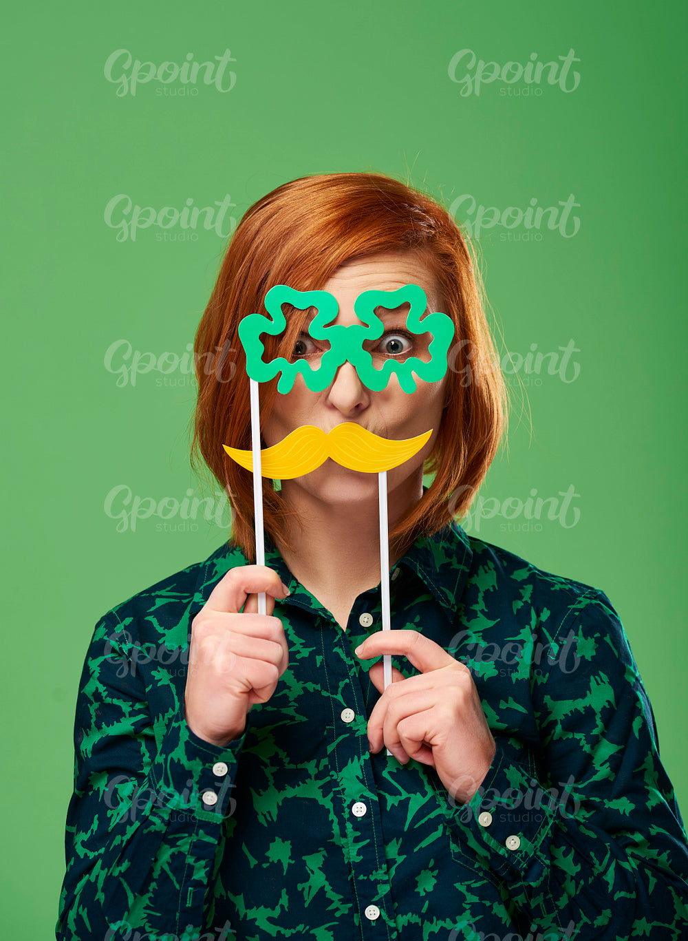 Portrait of playful woman with mustache and clover shaped glasses