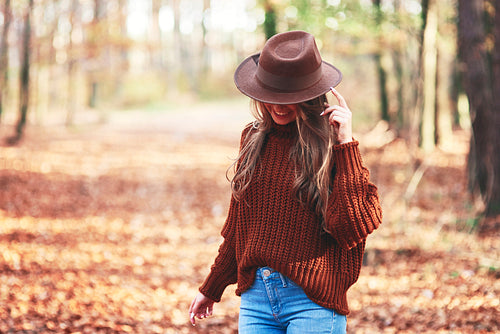 Gorgeous young woman wearing warm clothes in autumn woods