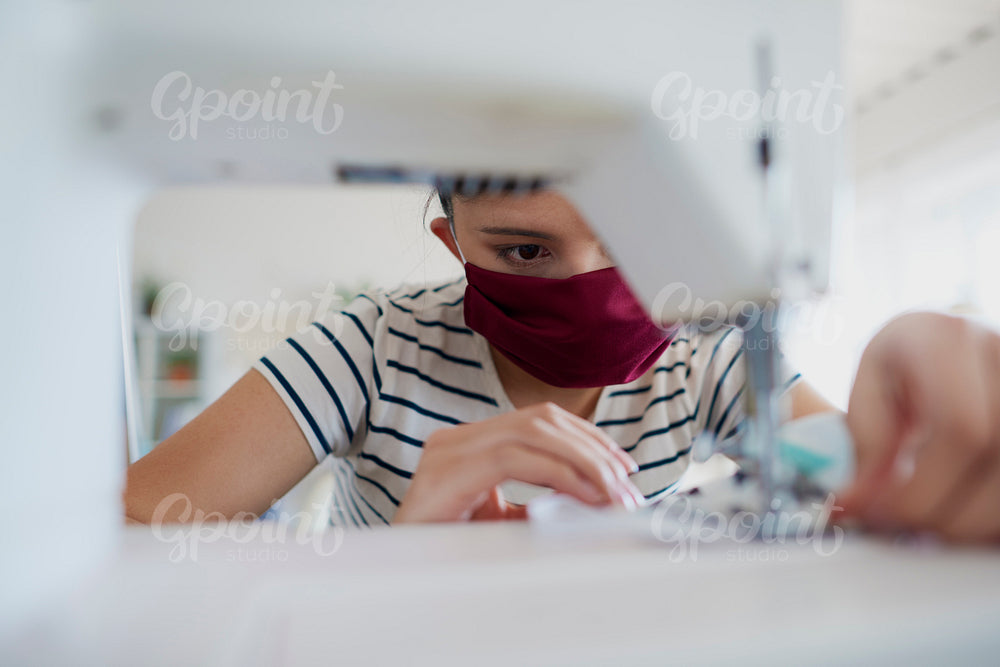 Close up of Asian woman sewing a pollution mask