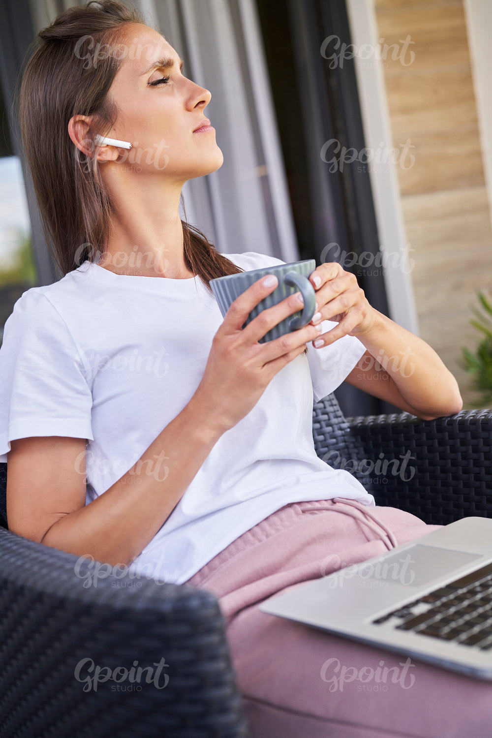 Vertical image of woman sitting outdoors