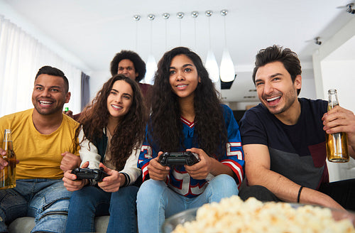 Group of friends playing on the console at home