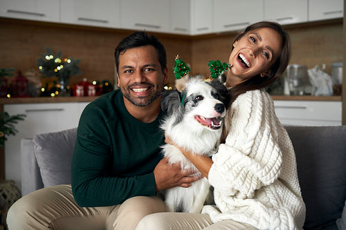 Portrait of happy couple with dog during the Christmas