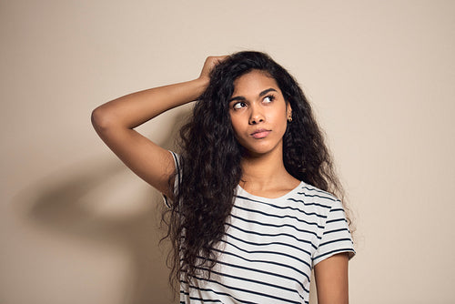 Mixed race young woman thinking about something
