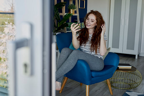 Woman using phone in the living room