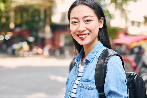 Portrait of Vietnamese young woman with backpack in the city