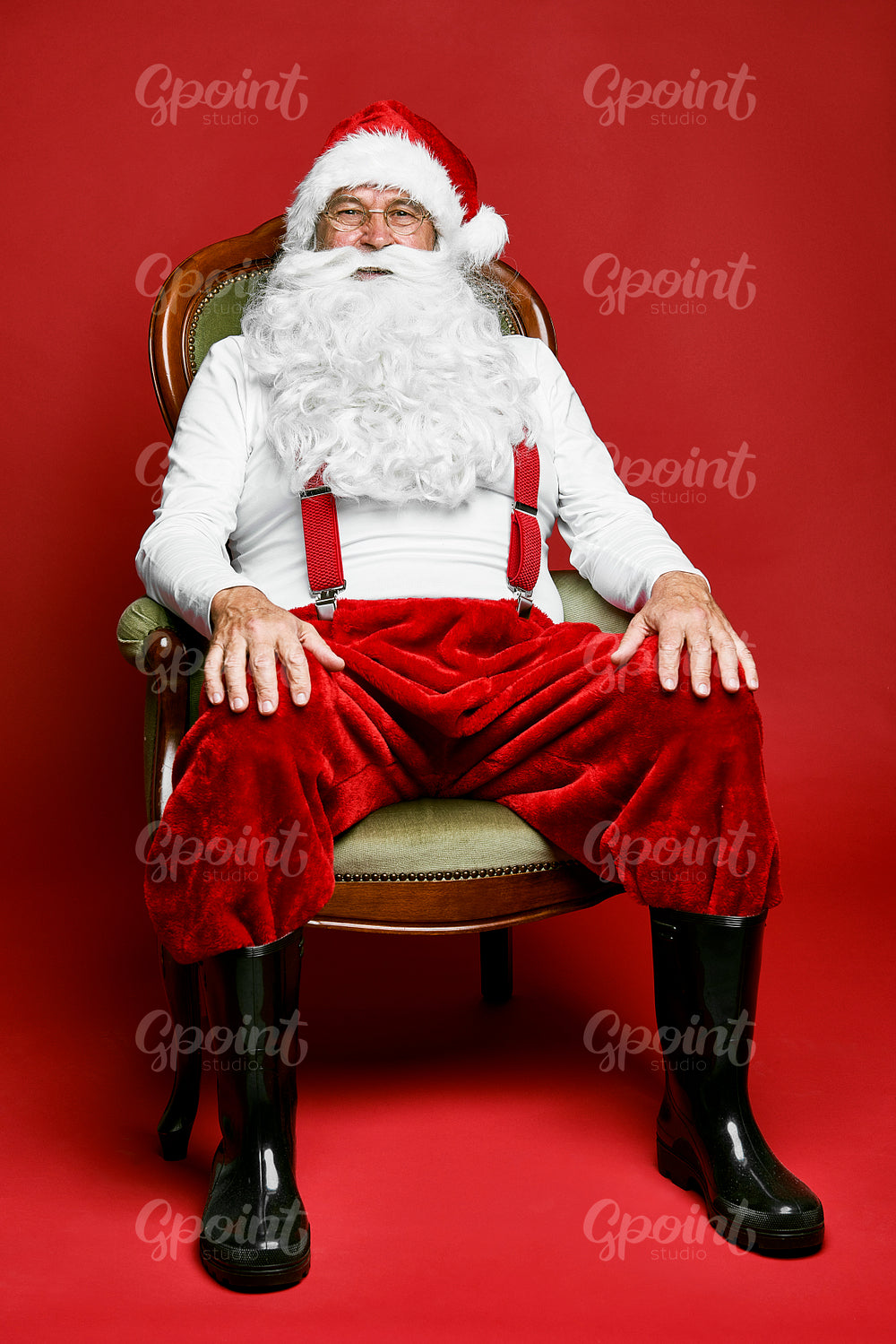 Portrait of caucasian Santa Claus sitting on the retro chair 