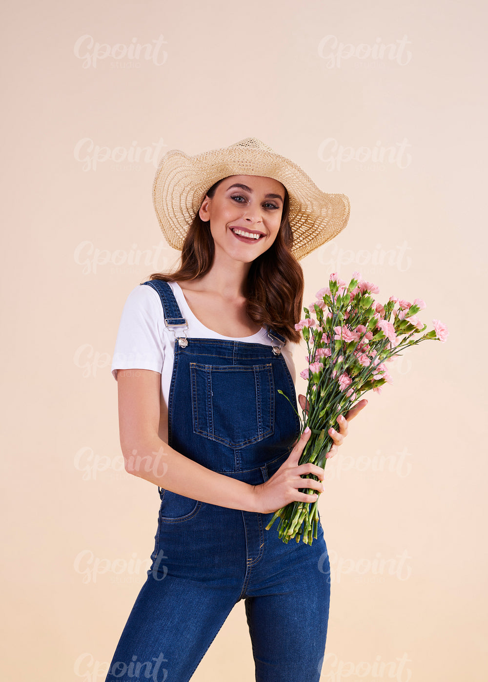 Portrait of smiling woman with bunch of flowers