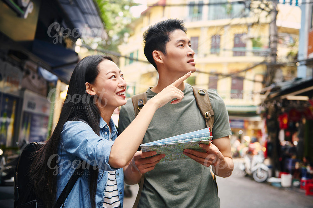 Vietnamese tourists with paper map