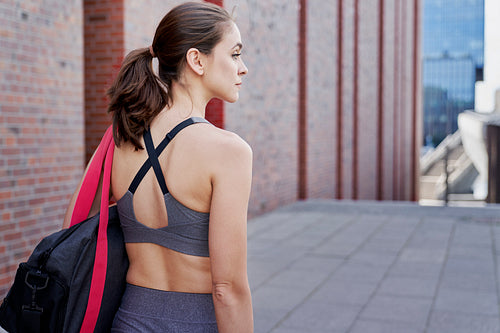 Rear view of athletic woman in training clothes
