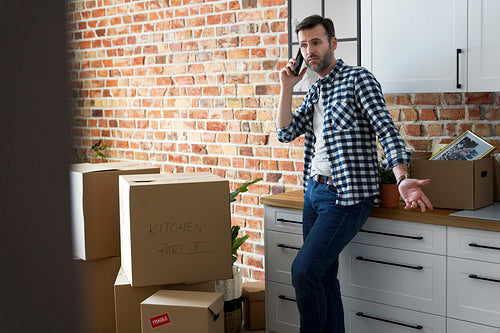 Displeased man calling during moving house