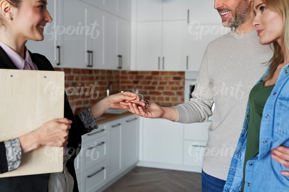 Real estate agent gives the keys to the clients