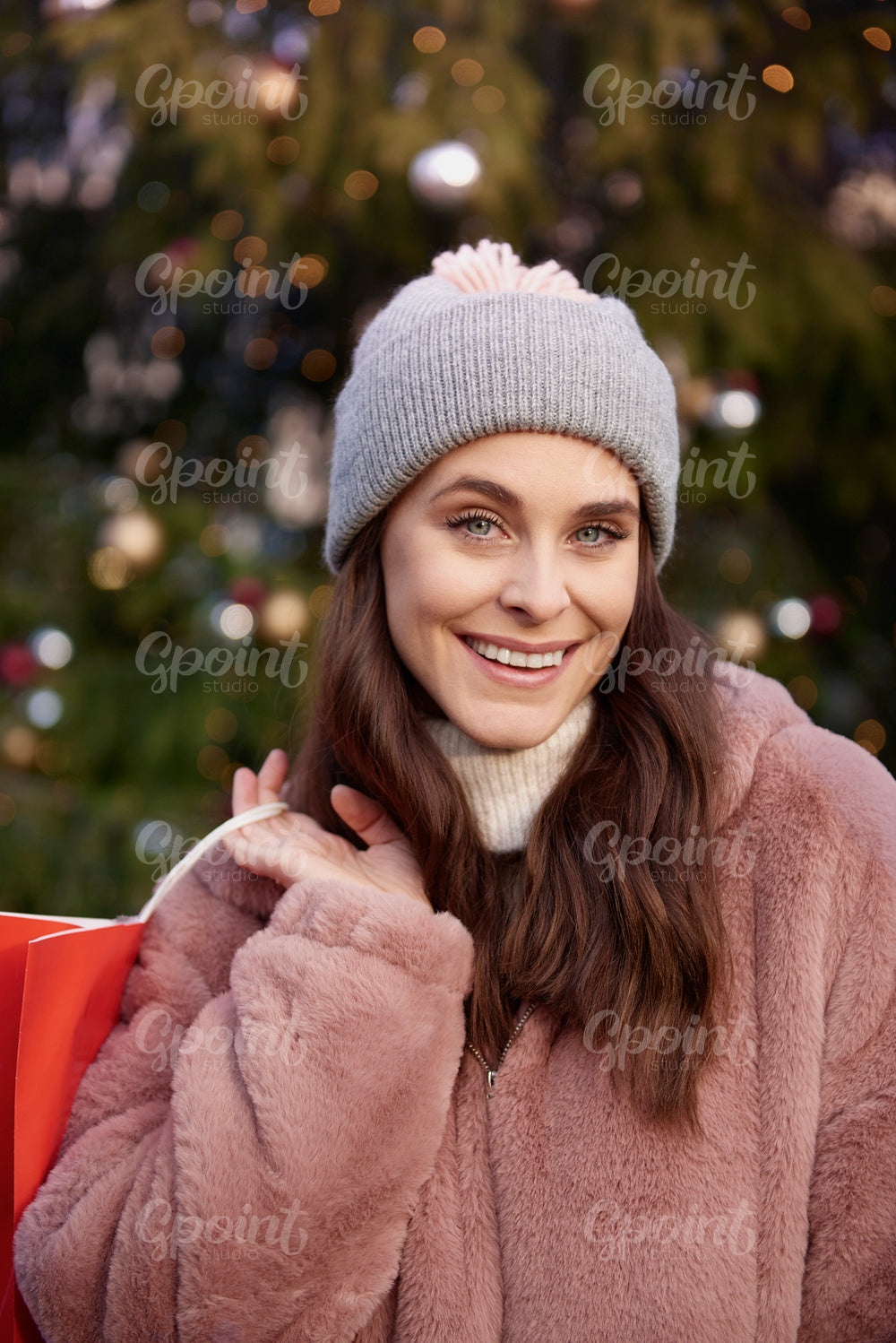 Portrait of woman with shopping bag on Christmas market