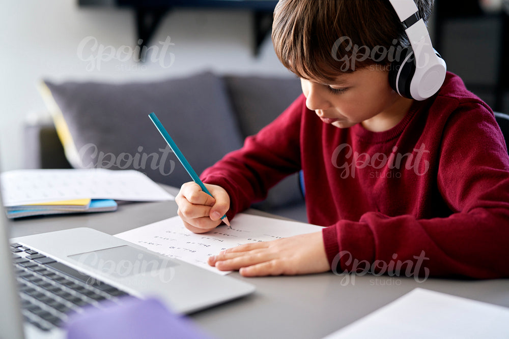 Boy doing homework while e-learning