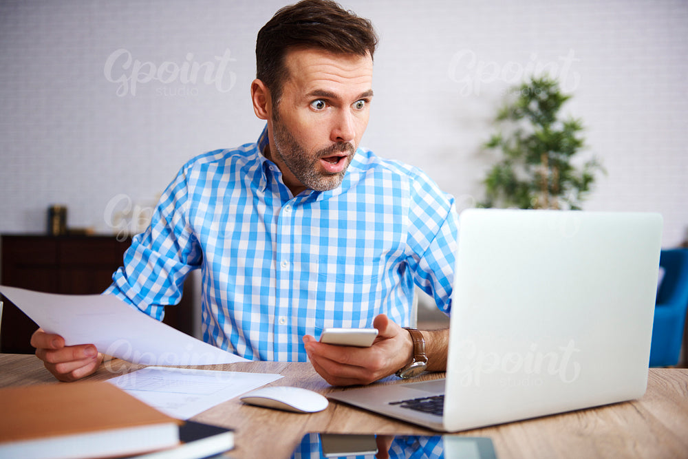 Shocked and worried businessman at work