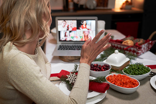 Woman spending Christmas dinner alone during a video call