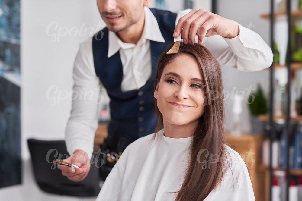 Young woman choosing of color to hair dye