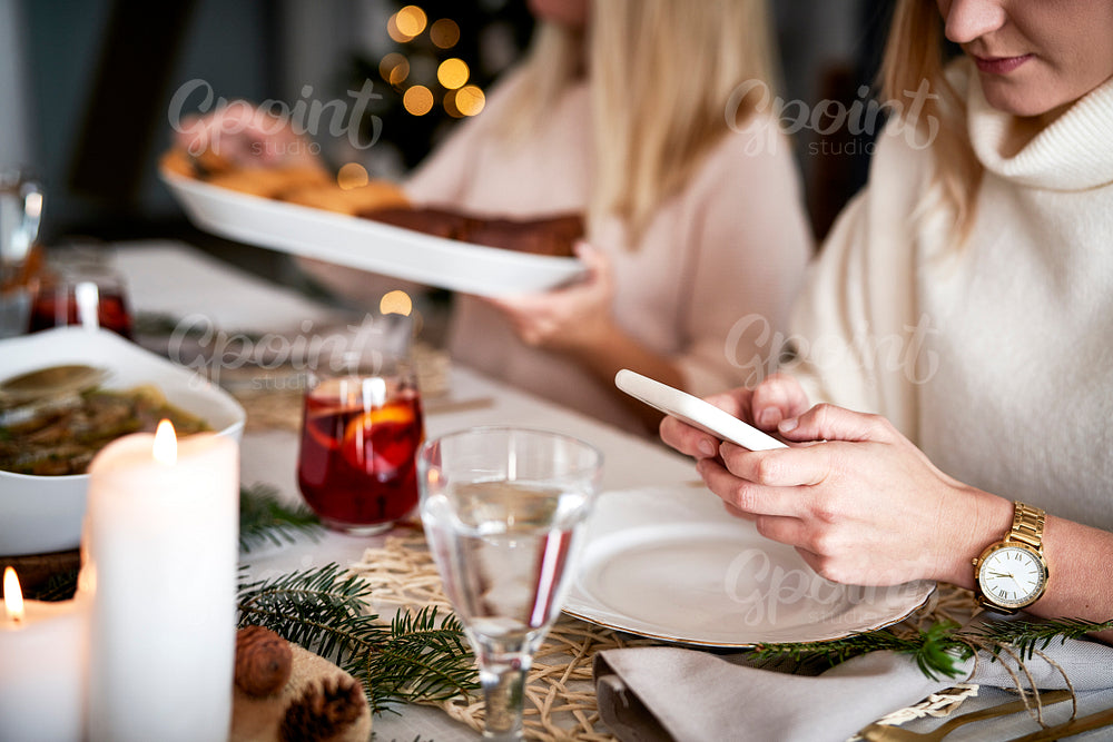 Woman using mobile phone at the Christmas Eve