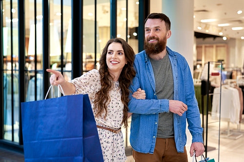 Smiling couple during shopping at the mall