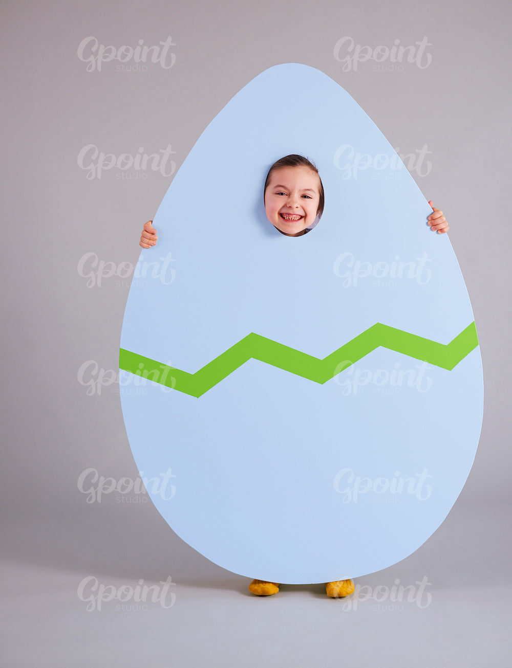 Cheerful child holding a huge easter egg