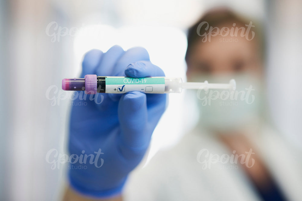 Positive coronavirus test in hand of a doctor