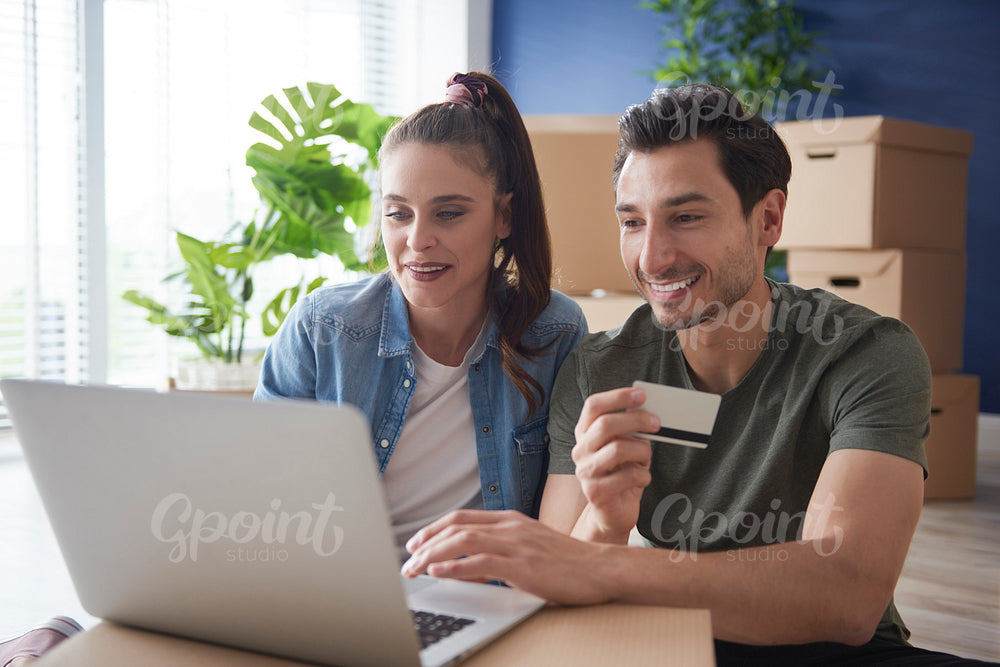 Couple doing shopping online for a new house