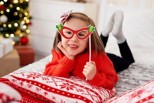 Portrait of playful girl in Christmas mask