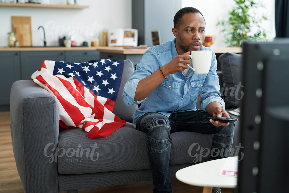 Black man affectionate in watching TV