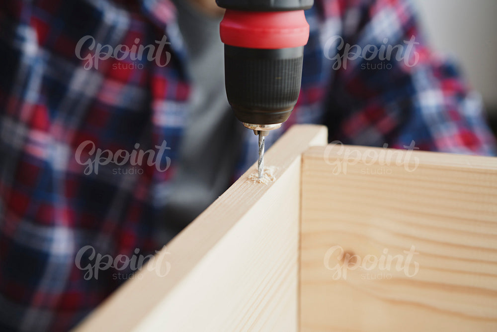 Detail of drilling on wooden plate