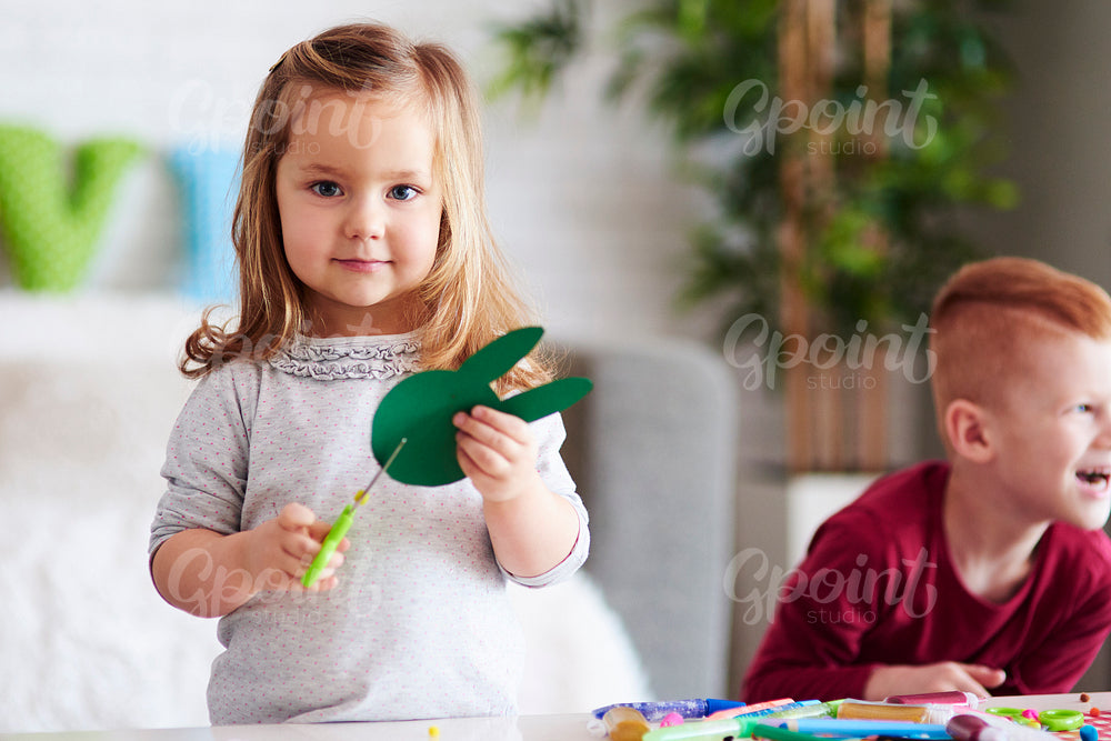 Cute girl preparing decorations for Easter