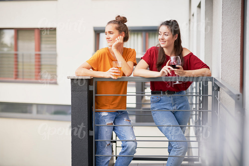 Two girls spending time relaxing on balcony