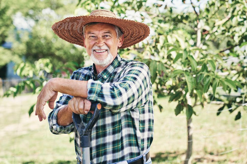 Portrait of happy farmer in a straw hat