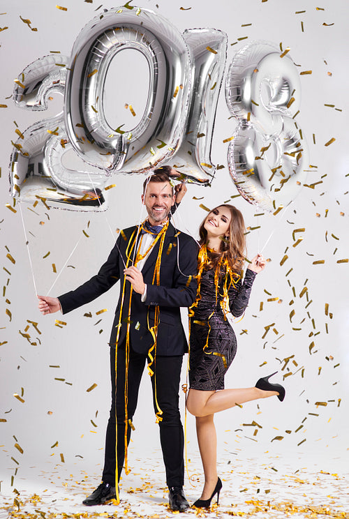 Couple posing with new year's balloons