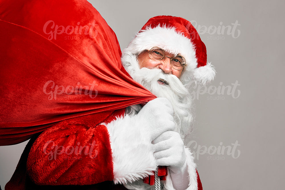 Portrait of caucasian Santa Claus with sack of presents 