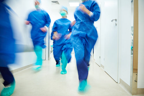 Running doctors going to help a patient